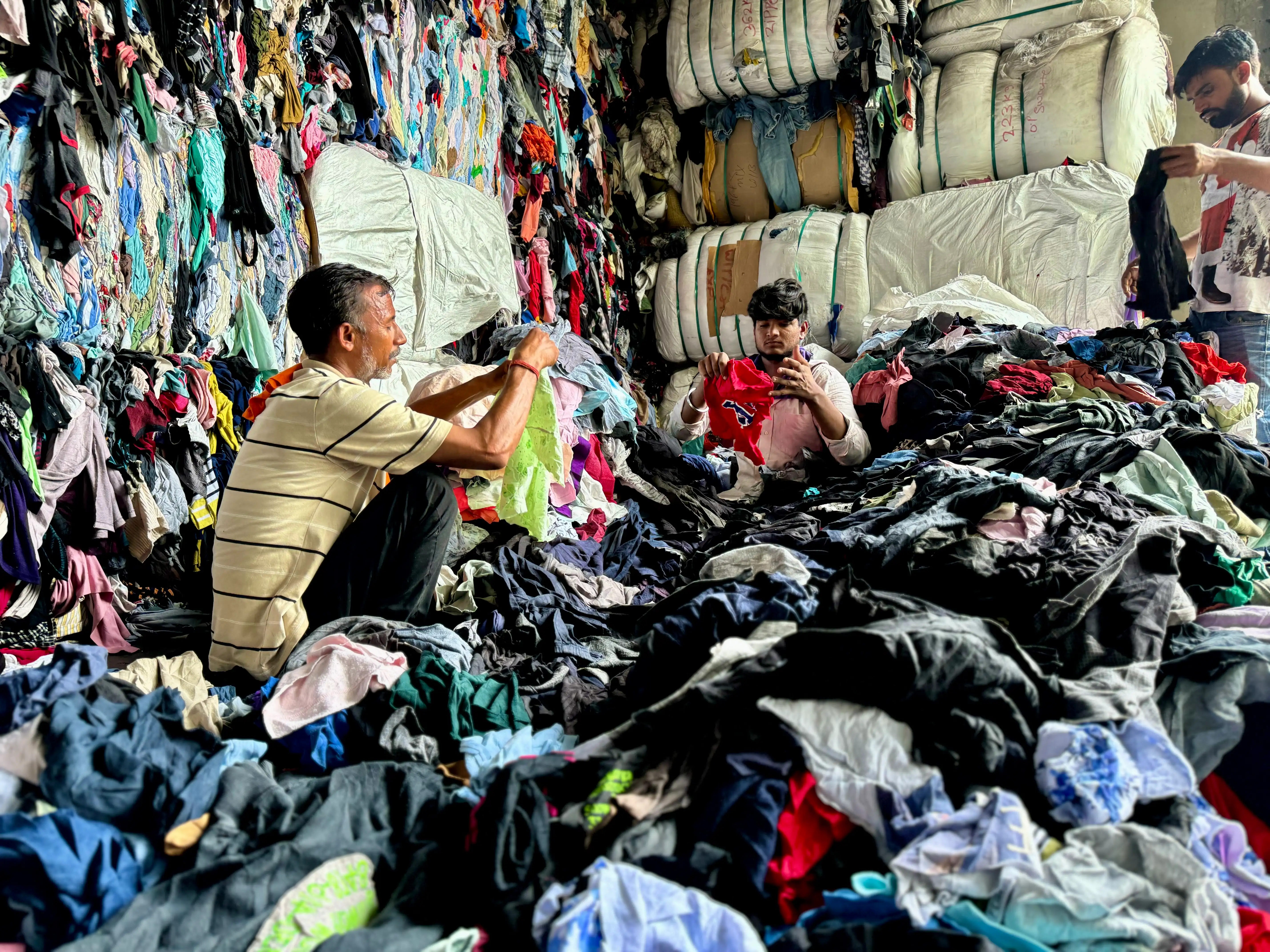 pile of clothes being sorted by materials to be cut into wipers